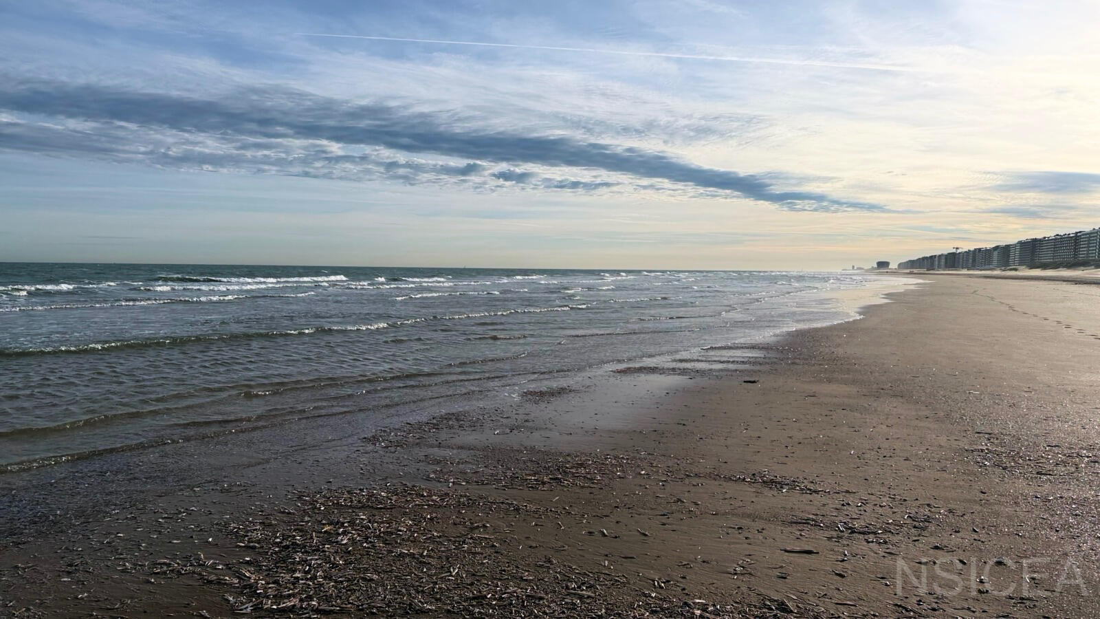 Coast_001 — evening/sunset shoreline North Sea shoreline at Oostende during evening light, with waves along the intertidal beach.